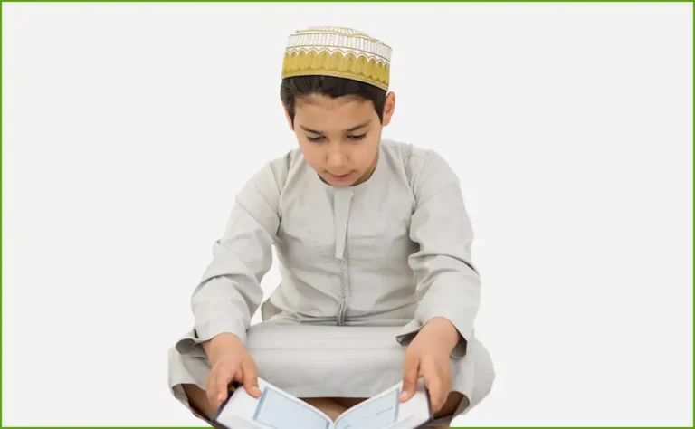 A young Muslim boy wearing a traditional Islamic cap and white attire, sitting on the floor and reciting the Quran with deep concentration. He is engaged in Quran memorization (Hifz), symbolizing dedication and spiritual growth.