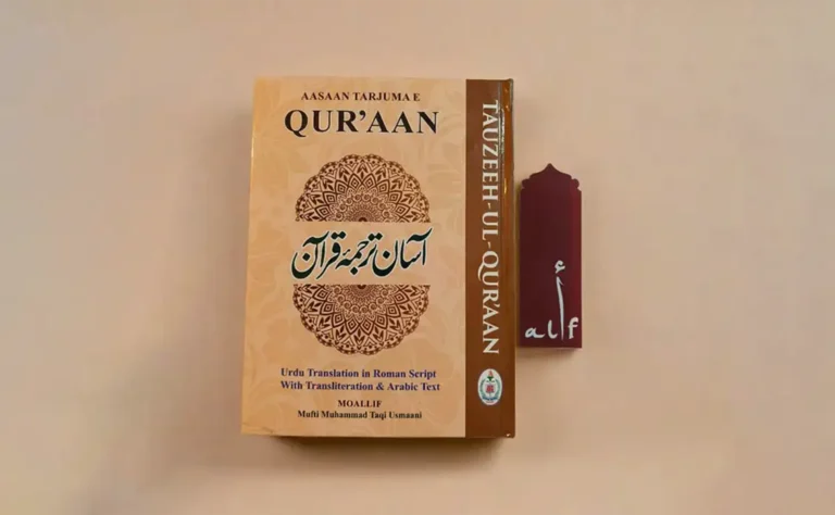 A beautifully designed book titled ‘Aasaan Tarjuma-e-Quran’ by Mufti Muhammad Taqi Usmani, featuring Urdu translation, transliteration, and Arabic text. A decorative bookmark with the Arabic letter ‘Alif’ is placed beside it, symbolizing the importance of understanding the Quran with translation and Tafsir.