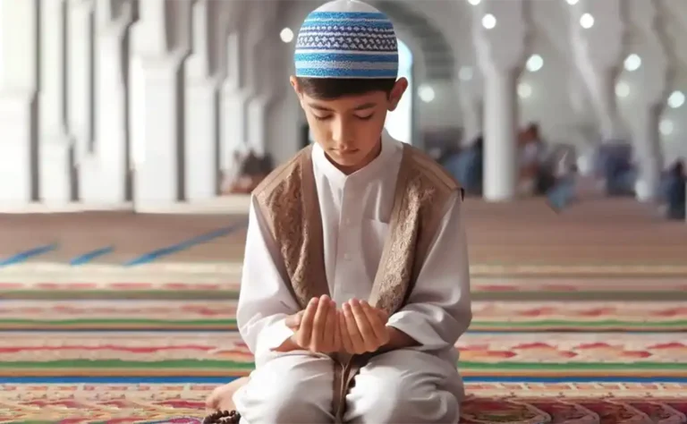 Muhammad Zayan, a 10-year-old Muslim boy wearing a traditional Islamic cap, sits in front of a laptop, attentively learning Islamic Studies and Daily Duas in an online one-on-one session. He is focused on his lesson while the teacher guides him through the screen. The study environment is peaceful, with an open Islamic studies book beside him